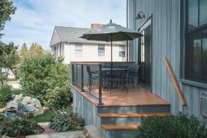 a deck with a table and an umbrella at Stay at Old Garden Beach in Rockport
