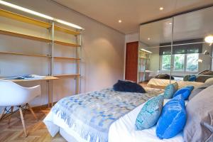 a bedroom with a bed with blue pillows on it at Apartment Barcelona Rentals - Classic Bonanova Apartment in Barcelona