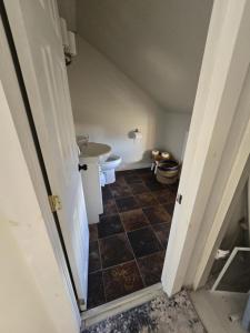 an attic bathroom with a toilet and a sink at Seaside Cottage 180 Views in Petit-Etang +18 photos