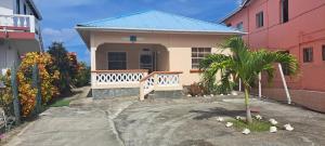 a small house with birds in front of it at PalmVille in Carriacou