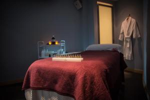 a bedroom with a bed with a red blanket at Regency Park Hotel, Health Club & Spa in Newbury