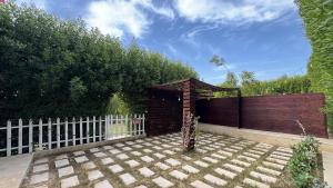 un giardino con recinzione in legno e gazebo di iBiZa Hostel a Beni Suef