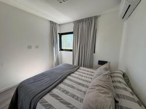 Postel nebo postele na pokoji v ubytování Casa con pileta en Funes + 12 fotografií