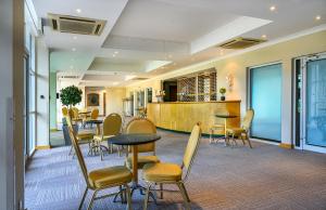 a lobby with tables and chairs and a bar at Regency Park Hotel, Health Club & Spa in Newbury