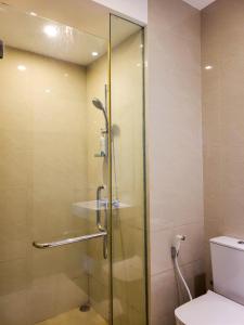 a glass shower in a bathroom with a toilet at Lake and Sea view apartment at Capitol twinpeak in Colombo +6 photos
