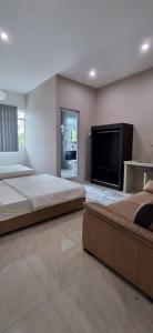 a bedroom with two beds and a flat screen tv at Cozy Nook in George Town