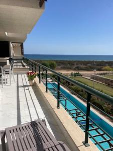 a balcony with a bench and a view of the ocean at Blue Retreat Suites by the Sea in Vokolidha +70 photos