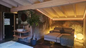 a living room with a couch and a wall at bläkat in Ramsau im Zillertal