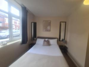a bed in a room with a window at West Park One Bedroom in South Shields +11 photos