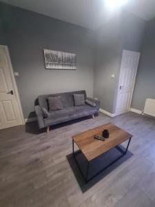 a living room with a couch and a coffee table at West Park One Bedroom in South Shields