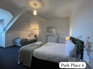 a hotel room with two beds and a chandelier at Park Place Apartments in Sunderland