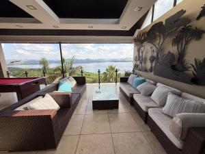 a living room with couches and a view of the ocean at MiCasa Hartbeespoort in Hartbeespoort