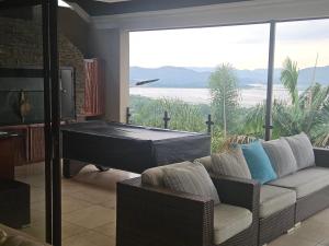 a living room with a pool table and a couch at Mi Casa in Hartbeespoort