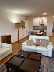a living room with two couches and a coffee table at La Maison in Mestre