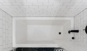 ein weiß gefliestes Badezimmer mit weißer Arbeitsplatte in der Unterkunft AuthenticATXBeauty,Fireplace,Walkto6thSt,BestEateries,Barbeccue in Austin + 24 Fotos