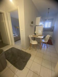 a living room with a table and two chairs and a table at Dimi's home in Komotini +4 photos