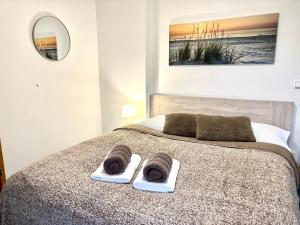 a bedroom with a bed with two towels on it at Penzion Sen in Černá v Pošumaví