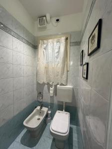 a small bathroom with a toilet and a sink at La Maison in Mestre +166 photos