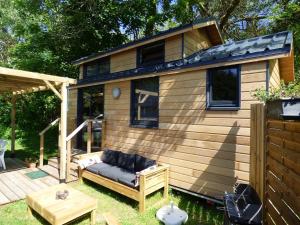 a tiny house with a couch in the yard at Tiny house Keremma in Tréflez