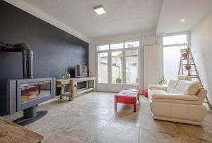 ein Wohnzimmer mit Kamin und Sessel in der Unterkunft Le chaource in Chaource