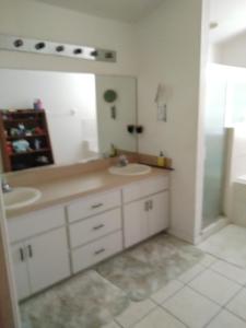 a bathroom with a sink and a mirror at La casa in Winter Haven