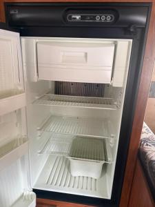een lege koelkast met de deur open in een keuken bij Ver-El RV Park & Campground in Concord