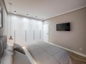 a bedroom with a bed and a tv on a wall at Arhitect INN in Sibiu +50 photos