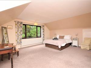 a bedroom with a bed and a desk and a window at 4 Bed in Cromer oc-kt116 in Cromer
