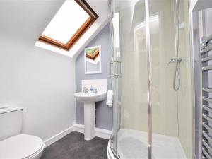 a bathroom with a shower and a toilet and a sink at 4 Bed in Cromer oc-kt116 in Cromer +23 photos