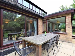 a wooden table and chairs on a patio at 4 Bed in Cromer oc-kt116 in Cromer