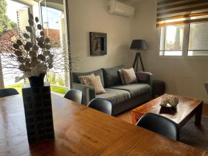a living room with a couch and a table at Bird’s Home in Aveiro