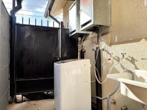 a kitchen with a small refrigerator and a sink at Arden Haus Estadías boutique Talca in Talca +16 photos