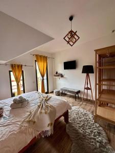 a bedroom with a large bed and a piano at Casa de Sub Munte Cozy Chalet in Fundata