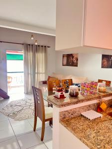 a kitchen and living room with a table and chairs at Angra Sea House in Angra dos Reis