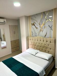 En eller flere senge i et værelse på Hospedaje GRAND H Rodadero & Suite