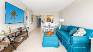 a living room with a blue couch and a table at Tranquility at MoonBay B - 304 in Key Largo +58 photos