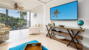 a living room with a flat screen tv on a wall at Tranquility at MoonBay B - 304 in Key Largo