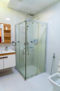 a glass shower in a bathroom with a sink at Samaik Thulusdhoo in Thulusdhoo