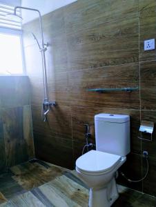a bathroom with a toilet and a shower at New Pensive Villa in Nuwara Eliya