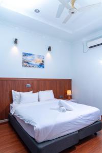 a bedroom with a large white bed in a room at Samaik Thulusdhoo in Thulusdhoo