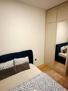a bedroom with a bed and a large mirror at Bulevar Pent in Sarajevo