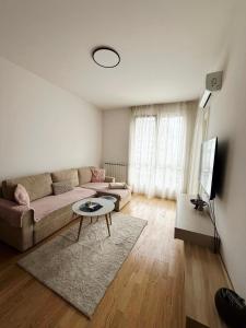 a living room with a couch and a table at Bulevar Pent in Sarajevo
