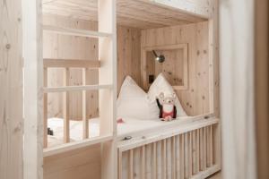a childs bunk bed with a stuffed animal on it at Gorfion Familienhotel in Malbun +84 photos