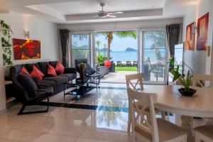 a living room with a couch and a table at Amore Villa by Utalay Koh Chang in Ban Khlong Son