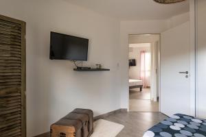 a living room with a flat screen tv on a wall at L'air de Riez in Saint-Hilaire-de-Riez