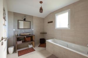 a bathroom with a bath tub and a sink at L'air de Riez in Saint-Hilaire-de-Riez +36 photos