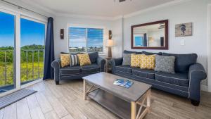 a living room with two couches and a table at Saltair Loft Ocean Pointe 2 BR 2 BA 1411 in Tavernier +72 photos