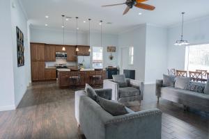 a living room with two couches and a kitchen at Pondfront Ranch • Theater Room • Sleeps 8 in Eagle Lake