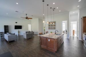 a kitchen and living room with a ceiling fan at Pondfront Ranch • Theater Room • Sleeps 8 in Eagle Lake