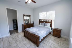 a bedroom with a bed and a dresser and a window at Pondfront Ranch • Theater Room • Sleeps 8 in Eagle Lake